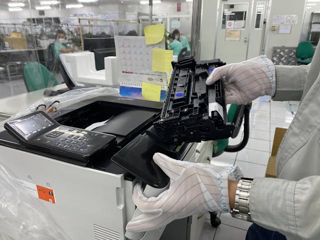 A technician checking the printer’s ink.